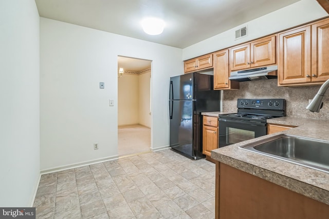 kitchen with sink, black appliances, and backsplash