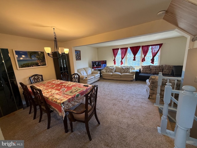 dining room with an inviting chandelier and carpet floors