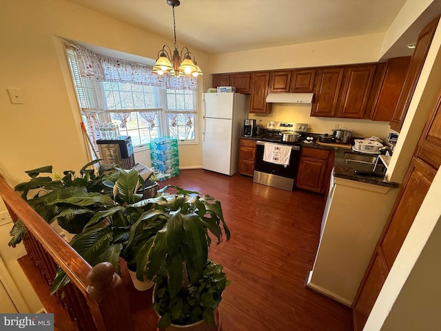 kitchen featuring stainless steel electric range oven, hanging light fixtures, white refrigerator, dark hardwood / wood-style floors, and a notable chandelier