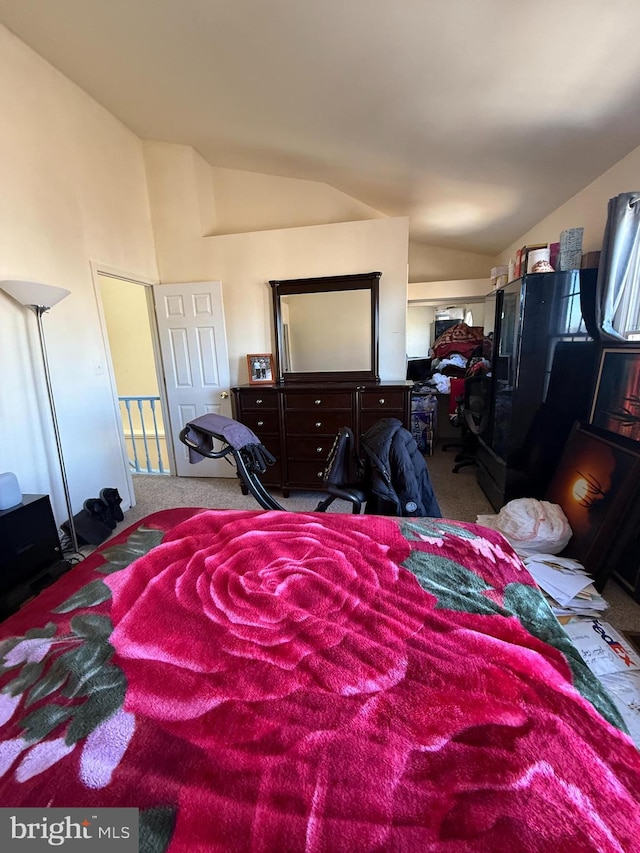 carpeted bedroom featuring lofted ceiling