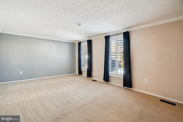 unfurnished room with crown molding, light colored carpet, and a textured ceiling