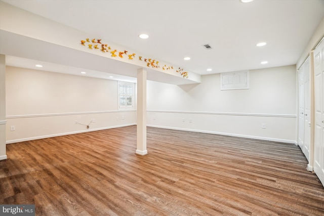 basement with hardwood / wood-style flooring