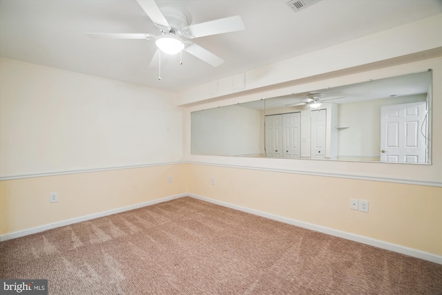 empty room featuring ceiling fan and carpet flooring