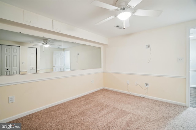 carpeted spare room with ceiling fan