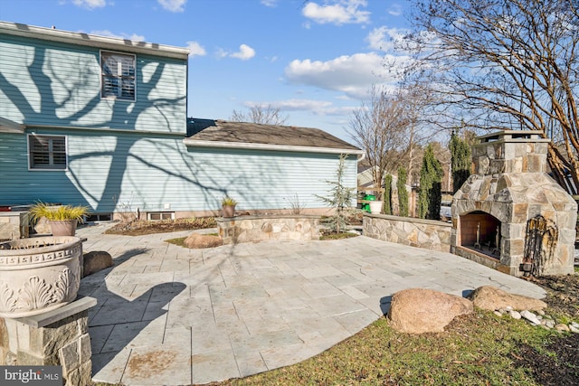 view of patio / terrace with an outdoor stone fireplace