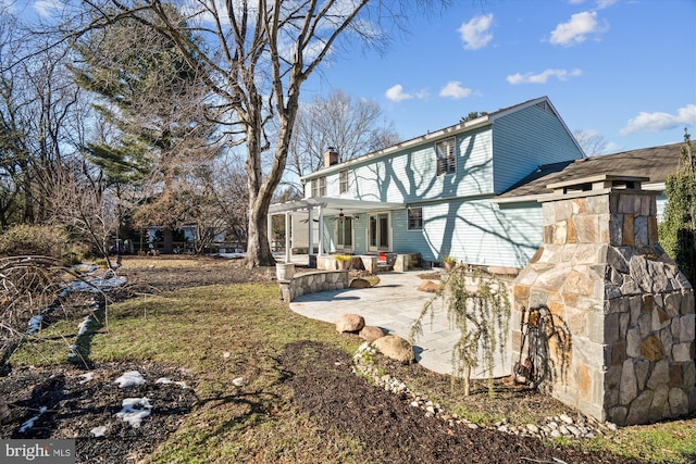 back of property featuring a pergola and a patio