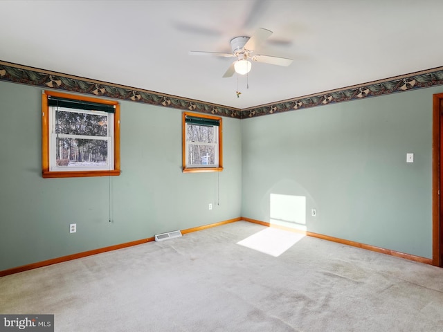 carpeted empty room with ceiling fan