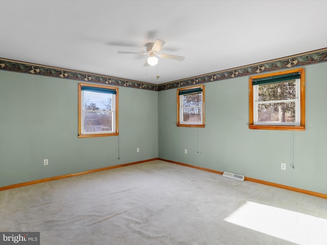 carpeted empty room featuring ceiling fan