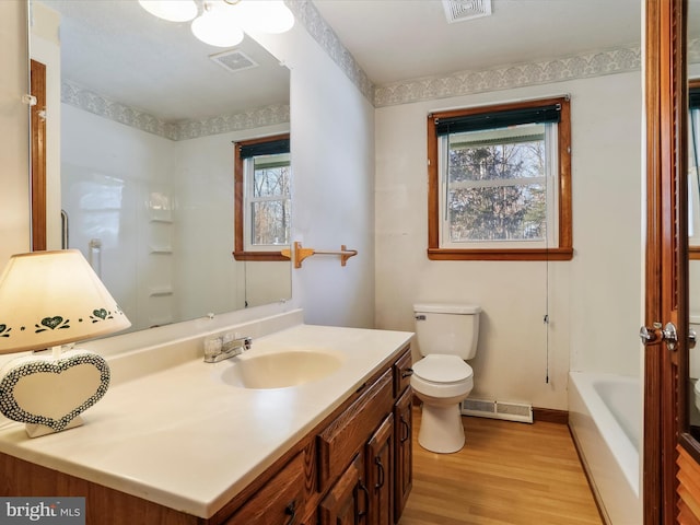 full bathroom with wood-type flooring, toilet, vanity, and plus walk in shower