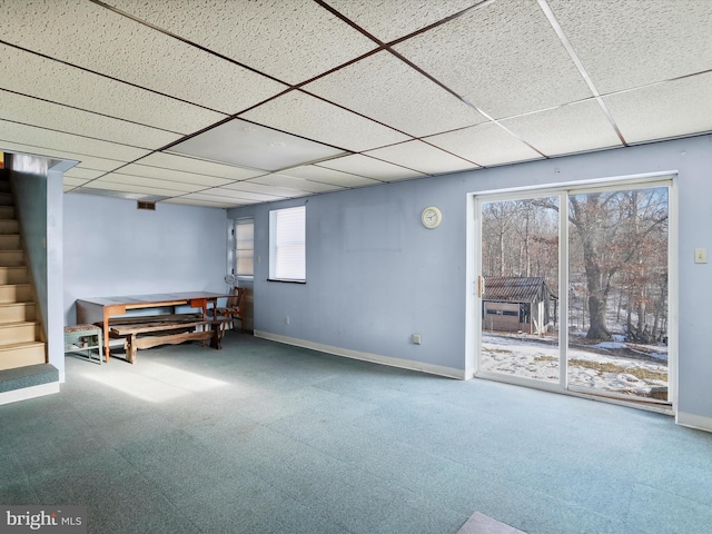 basement with carpet floors and a paneled ceiling