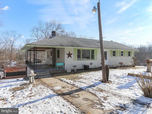 single story home featuring a porch and central air condition unit