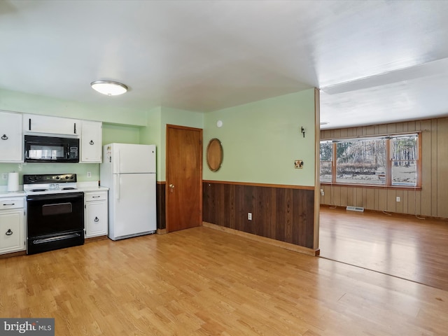 kitchen featuring white fridge, electric range oven, white cabinets, and light hardwood / wood-style flooring