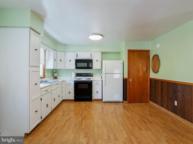 kitchen featuring electric stove, sink, white cabinets, and white refrigerator