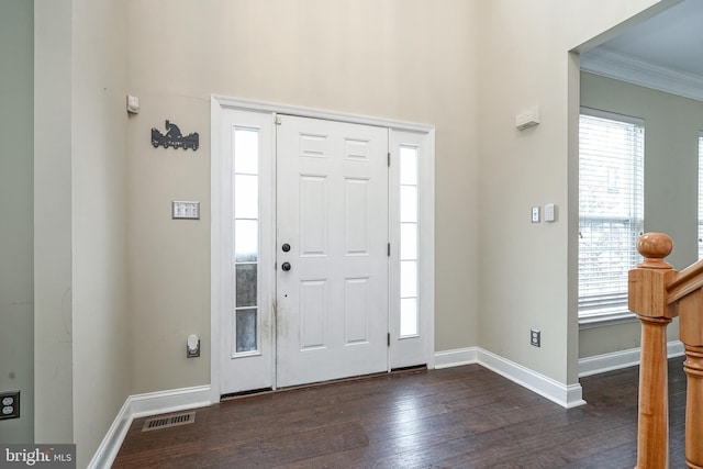 entryway featuring dark wood-type flooring and crown molding