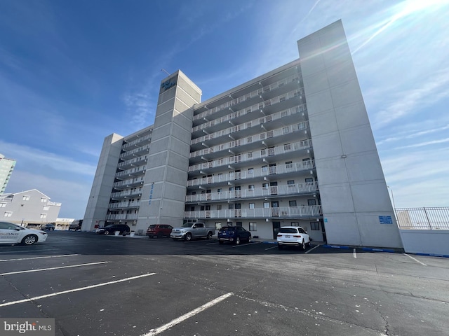 view of building exterior with uncovered parking