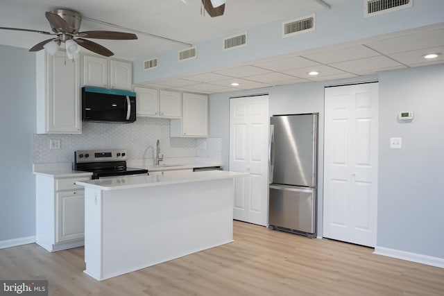 kitchen featuring appliances with stainless steel finishes, visible vents, and ceiling fan