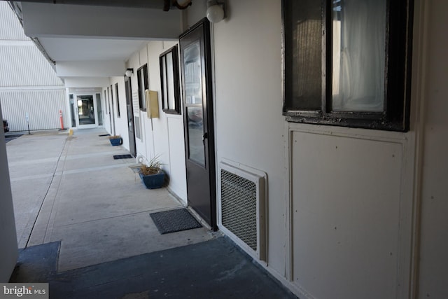 hallway featuring concrete flooring and heating unit