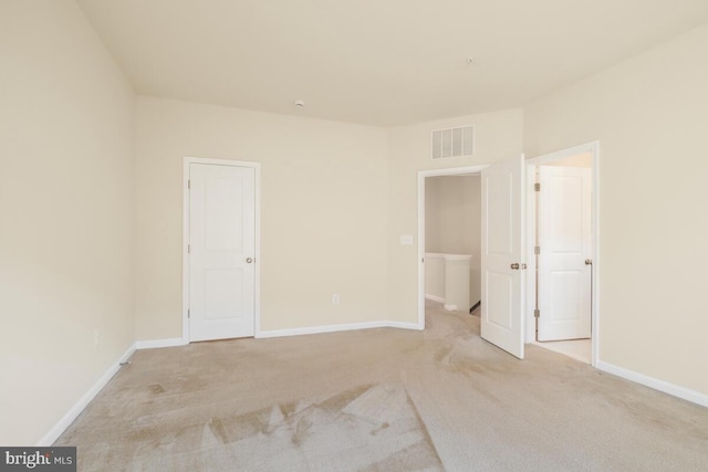 unfurnished room with light carpet