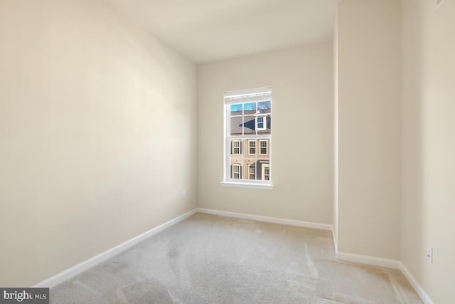 unfurnished room featuring light carpet