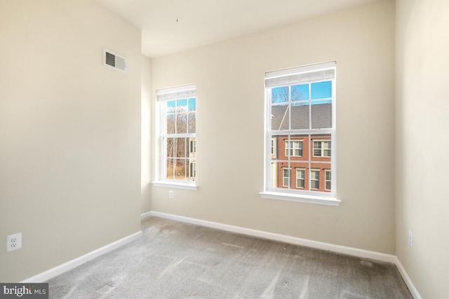 unfurnished room featuring light colored carpet