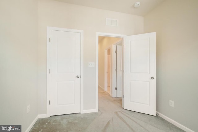 unfurnished bedroom with light carpet