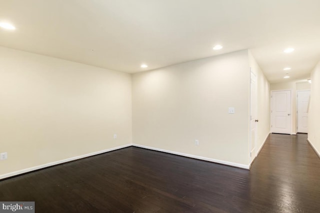 spare room with dark hardwood / wood-style flooring