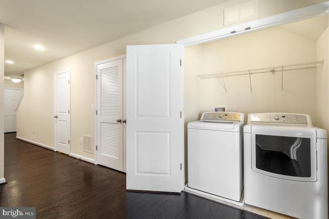 laundry area with washer and dryer and dark hardwood / wood-style floors