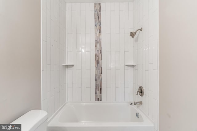 bathroom featuring bathing tub / shower combination and toilet