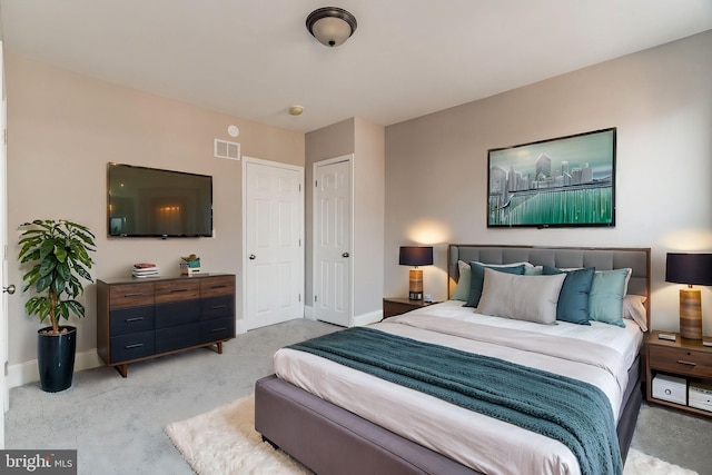 bedroom with light carpet, baseboards, and visible vents