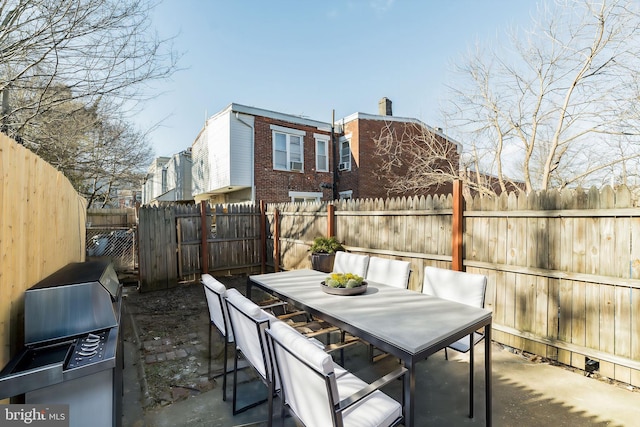 view of patio with a fenced backyard, outdoor dining area, and area for grilling