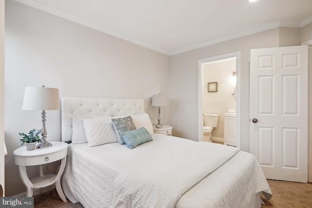 carpeted bedroom with crown molding and ensuite bathroom