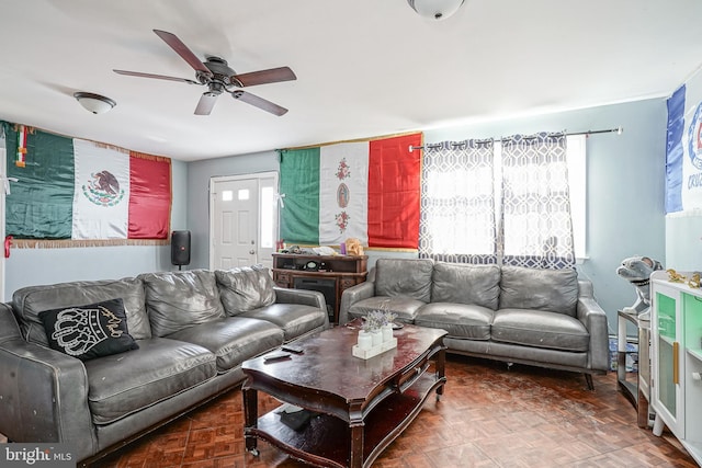 living room with dark parquet flooring and ceiling fan