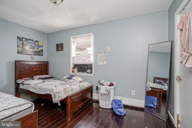 bedroom featuring hardwood / wood-style flooring and a baseboard radiator