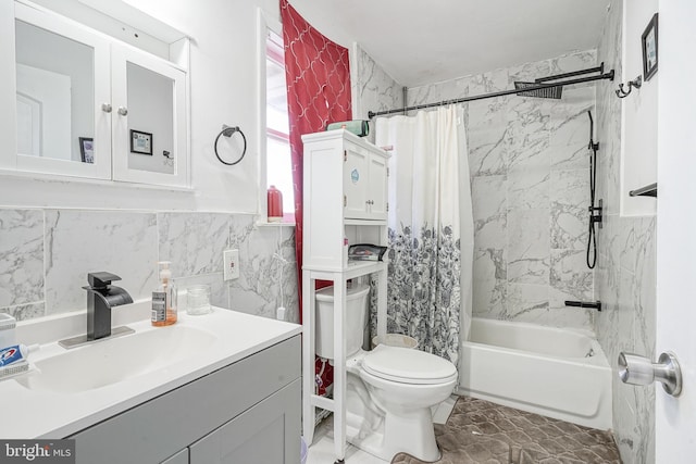 full bathroom featuring vanity, toilet, shower / bath combo with shower curtain, and tile walls