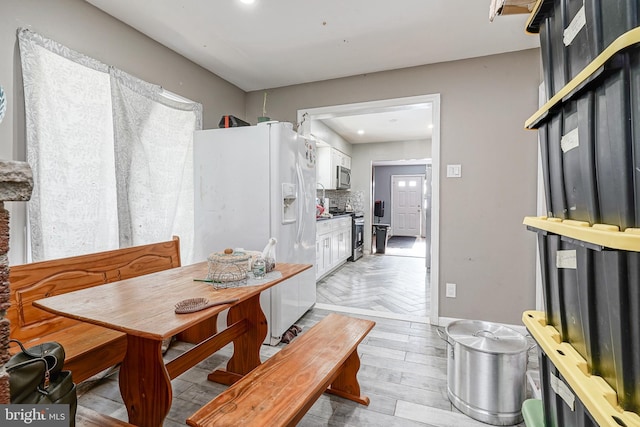 dining space featuring light parquet floors