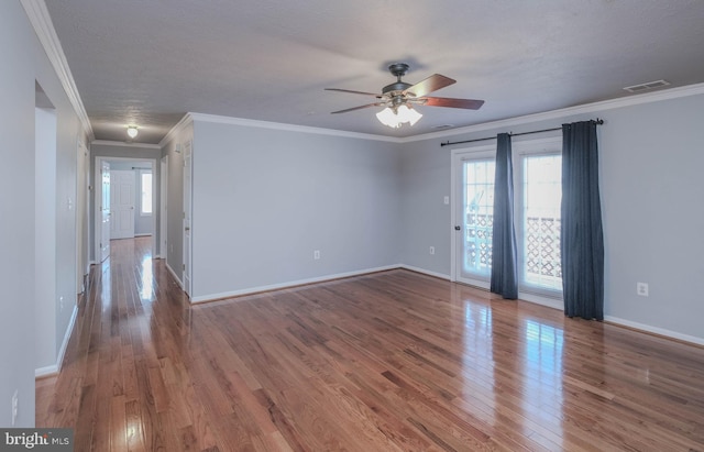 unfurnished room with wood-type flooring, ornamental molding, a textured ceiling, and ceiling fan