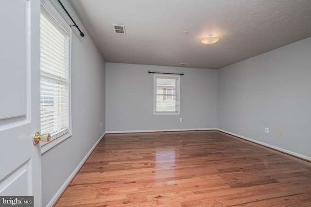 empty room with hardwood / wood-style floors