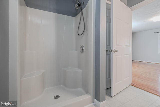 bathroom with tile patterned flooring and walk in shower