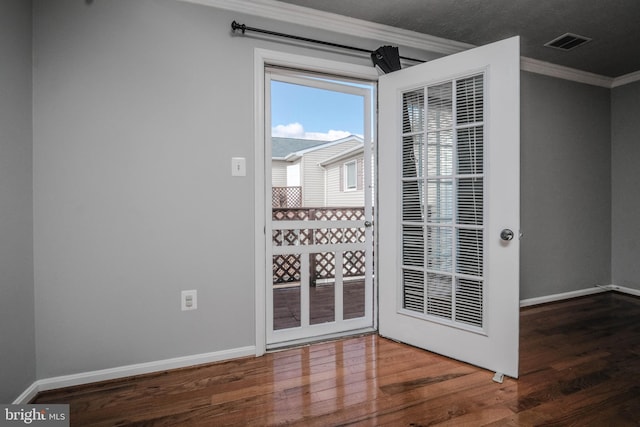 unfurnished room featuring crown molding and dark hardwood / wood-style floors