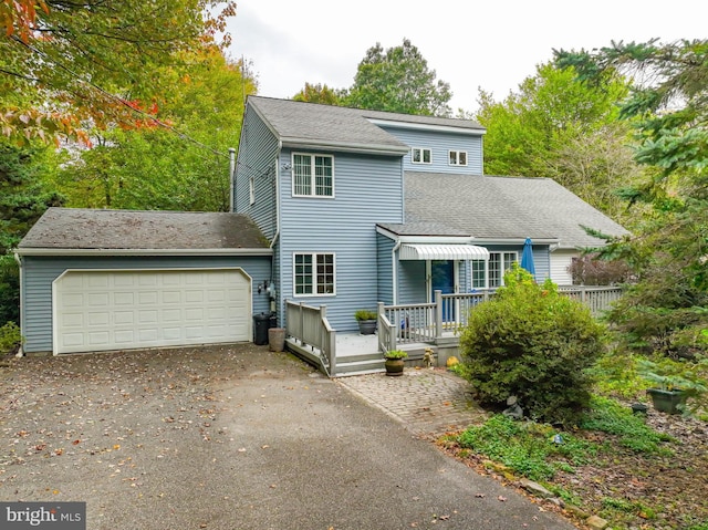 view of front of house with a garage and a deck