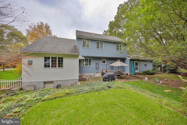 rear view of house with a lawn