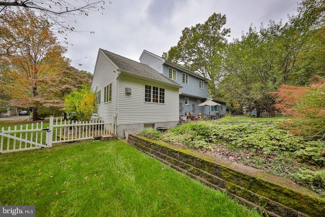 view of side of property featuring a yard