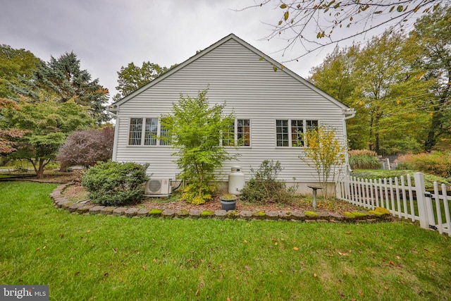 view of home's exterior with a yard and ac unit