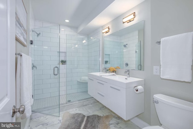 bathroom with vanity, toilet, and a shower with shower door