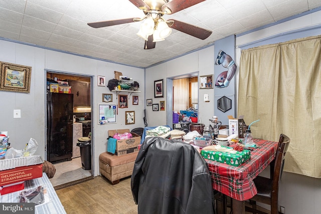 dining space with light wood-style floors and a ceiling fan