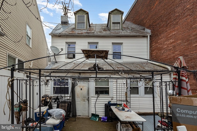 rear view of property with a chimney