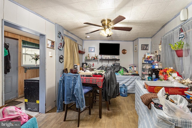 dining space with light wood-type flooring and a ceiling fan