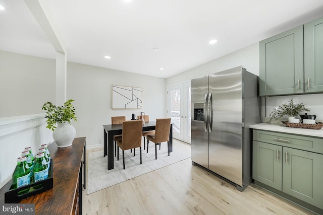 dining room with light wood-type flooring, french doors, and recessed lighting