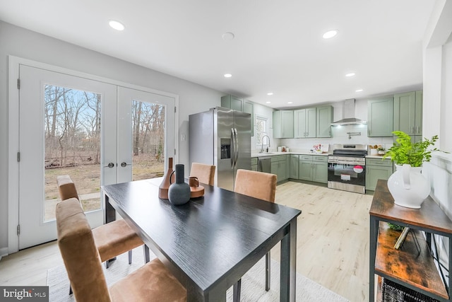 dining space with recessed lighting, french doors, and light wood-style flooring