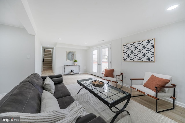 living room featuring recessed lighting, baseboards, stairs, french doors, and light wood finished floors